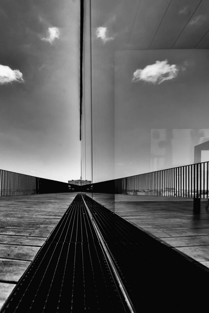 A solitary light above a graphic black and white walkway